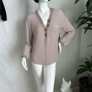 Light weight waffle style knit V-neck top.